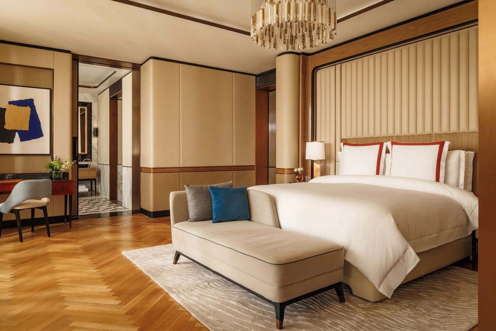 A bedroom with a chaise longue and wooden floors