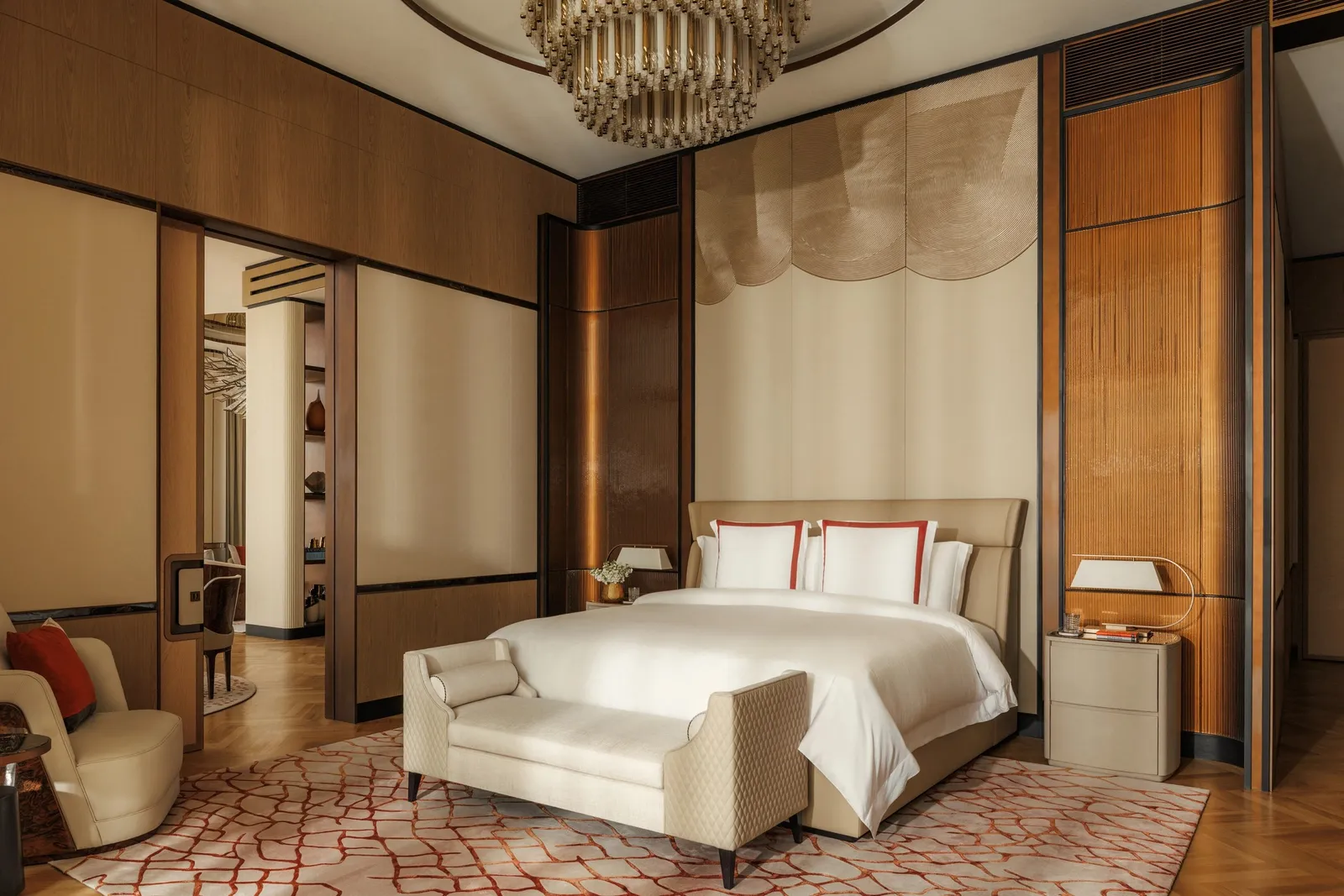 A bedroom with a sculpted headboard in warm light