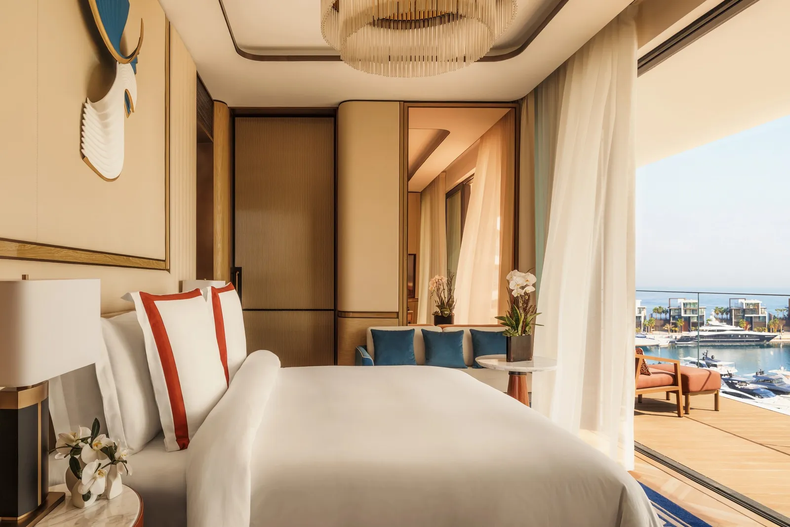 A bedroom with a white bed and a wave-shaped relief