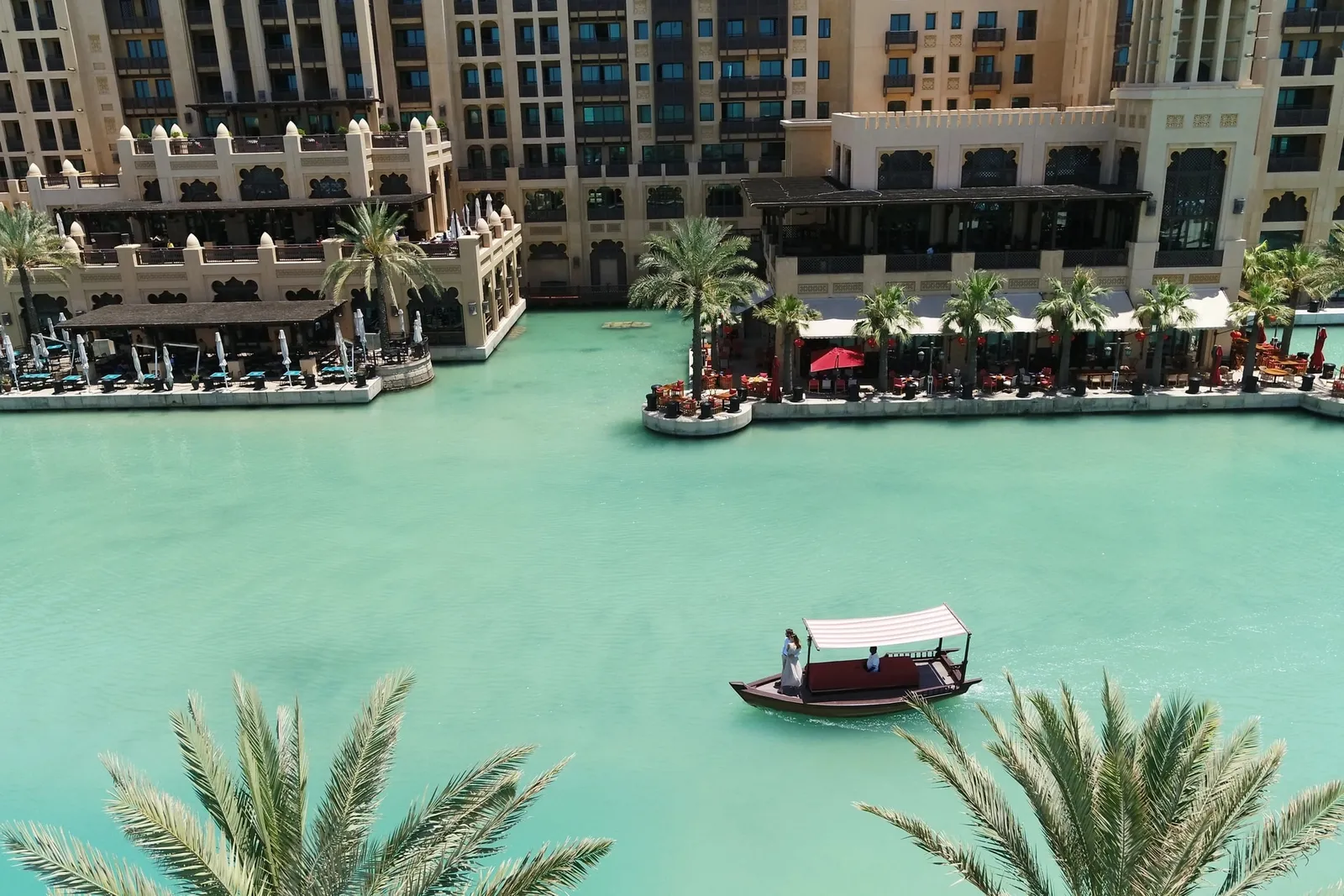 Abra boats on the green water of Madinat Jumeirah