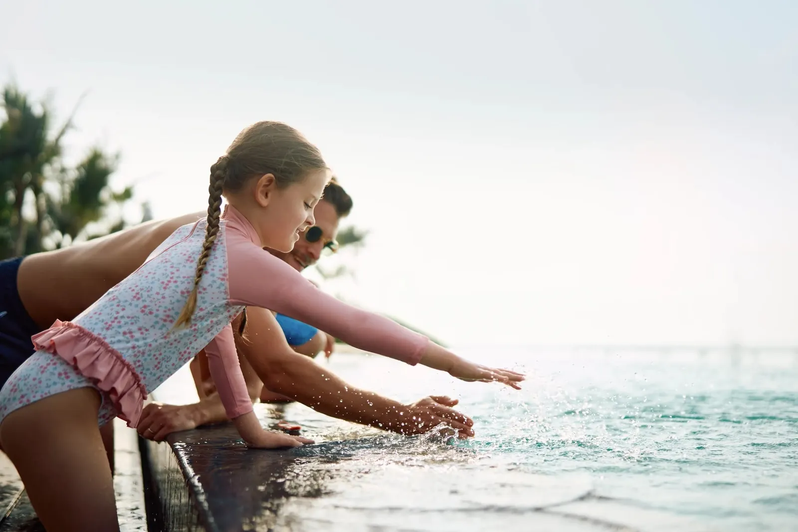 A child playing in shallow water beside the hotel beach