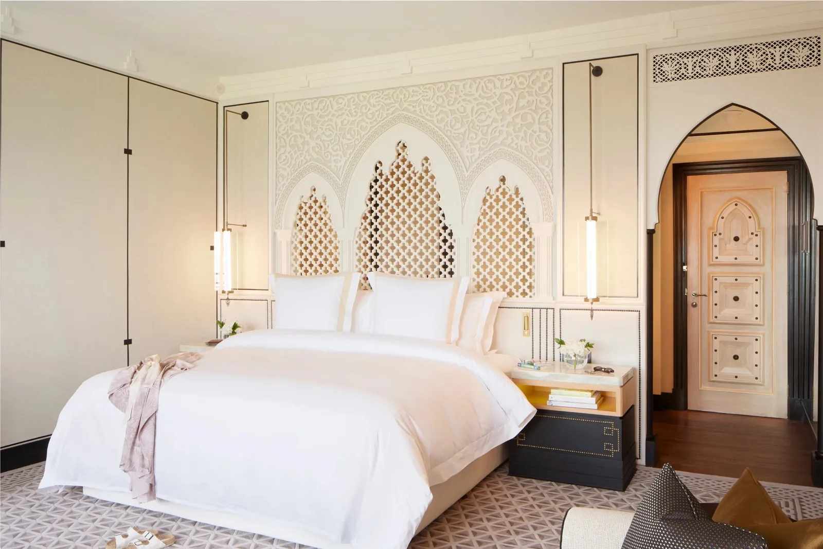 The bed and decorated headboard in a Club Arabian room