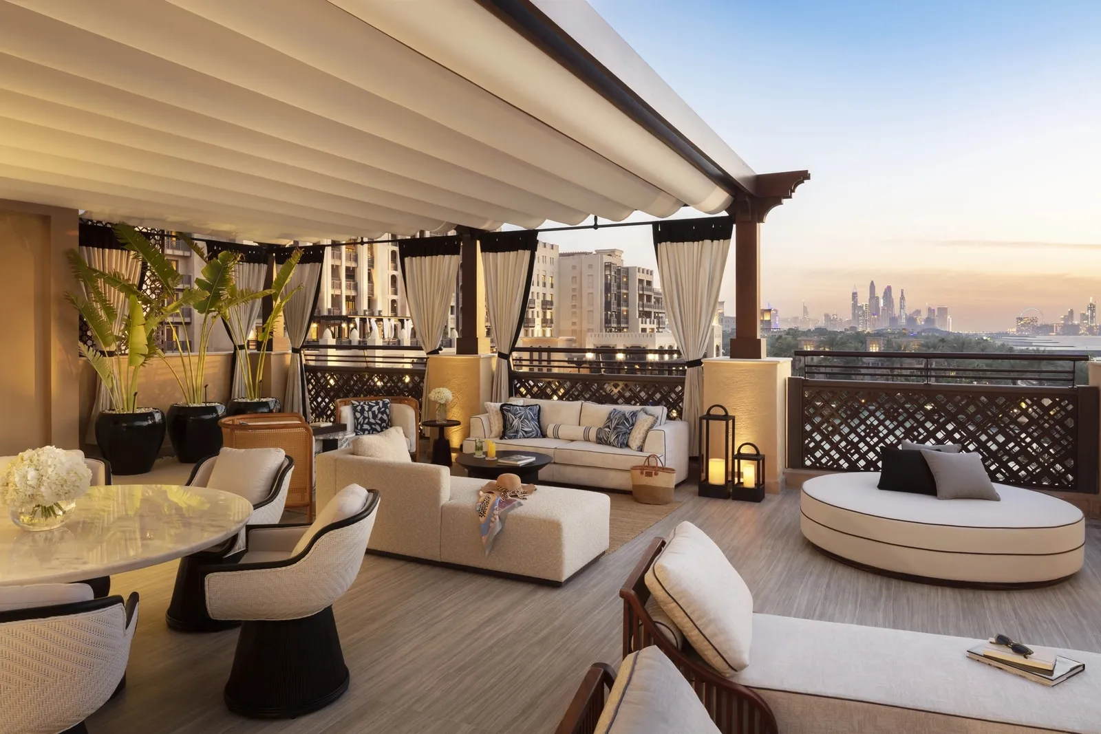 A covered outdoor sitting area on the terrace of the 2-bedroom suite