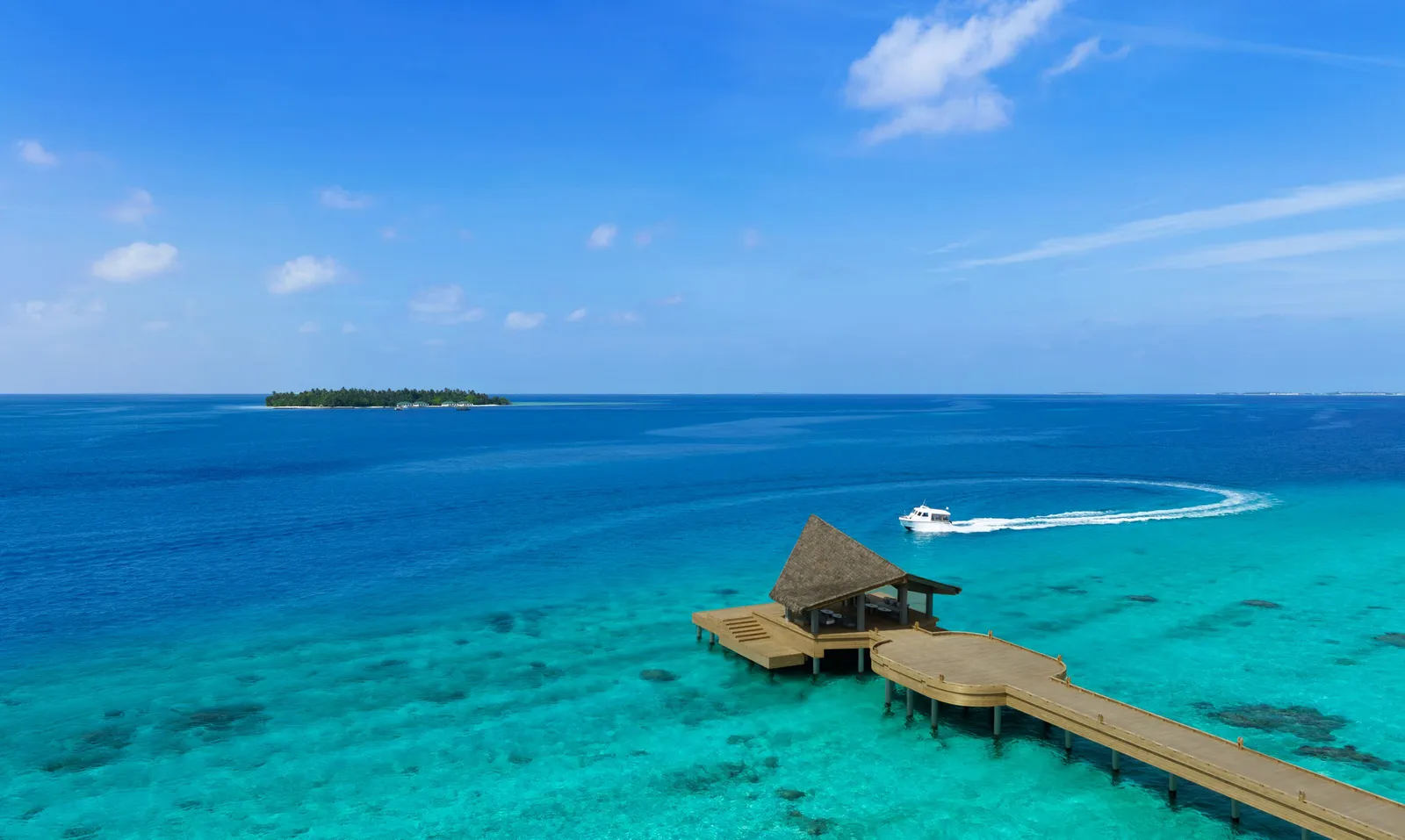 The arrival jetty in the lagoon, a speedboat coming in