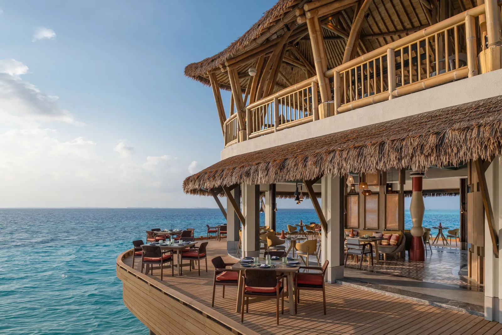 Athiri over the water, its terrace and thatched roof