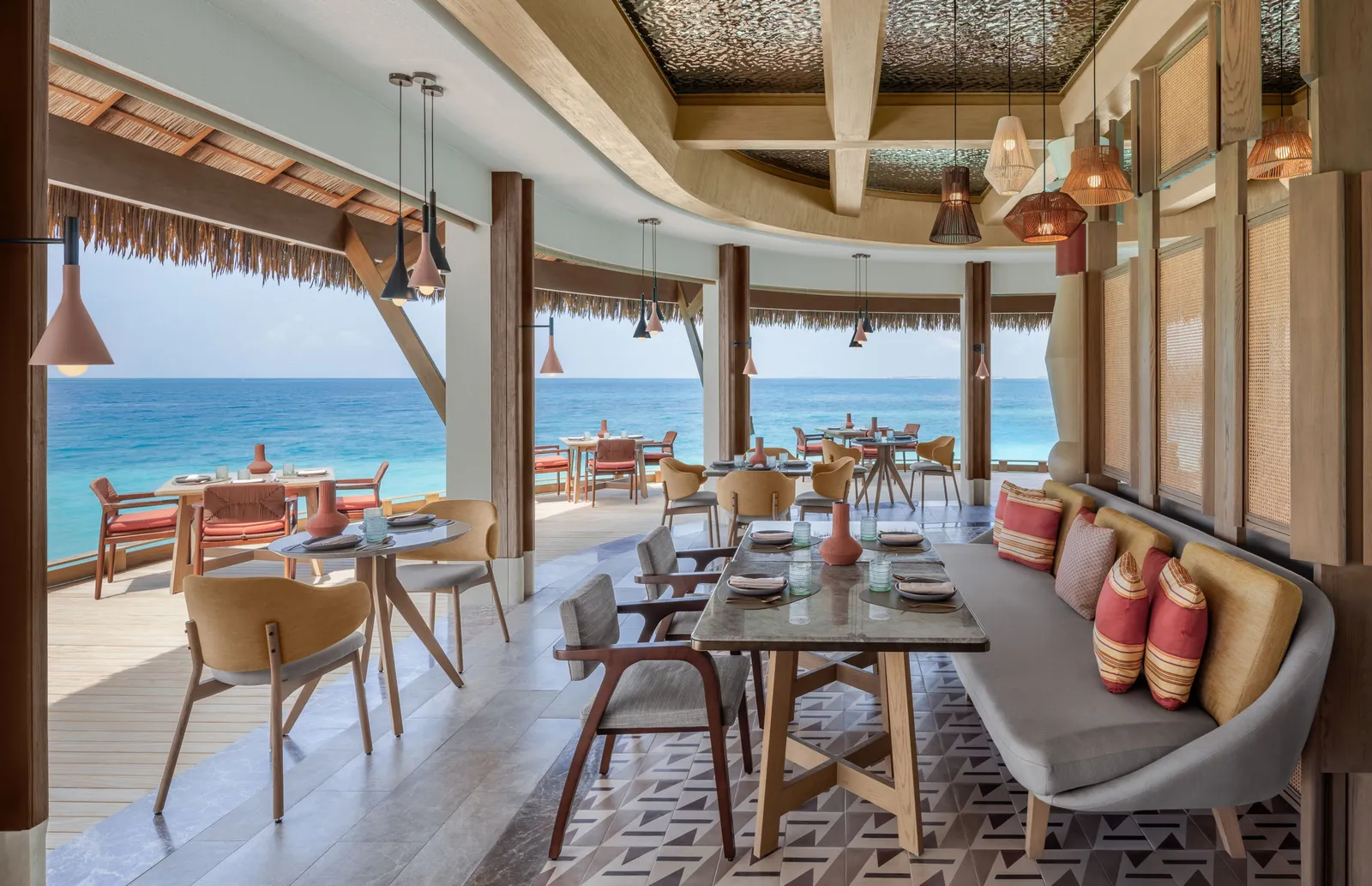 Athiri’s dining room, open to the ocean, with copper lamps