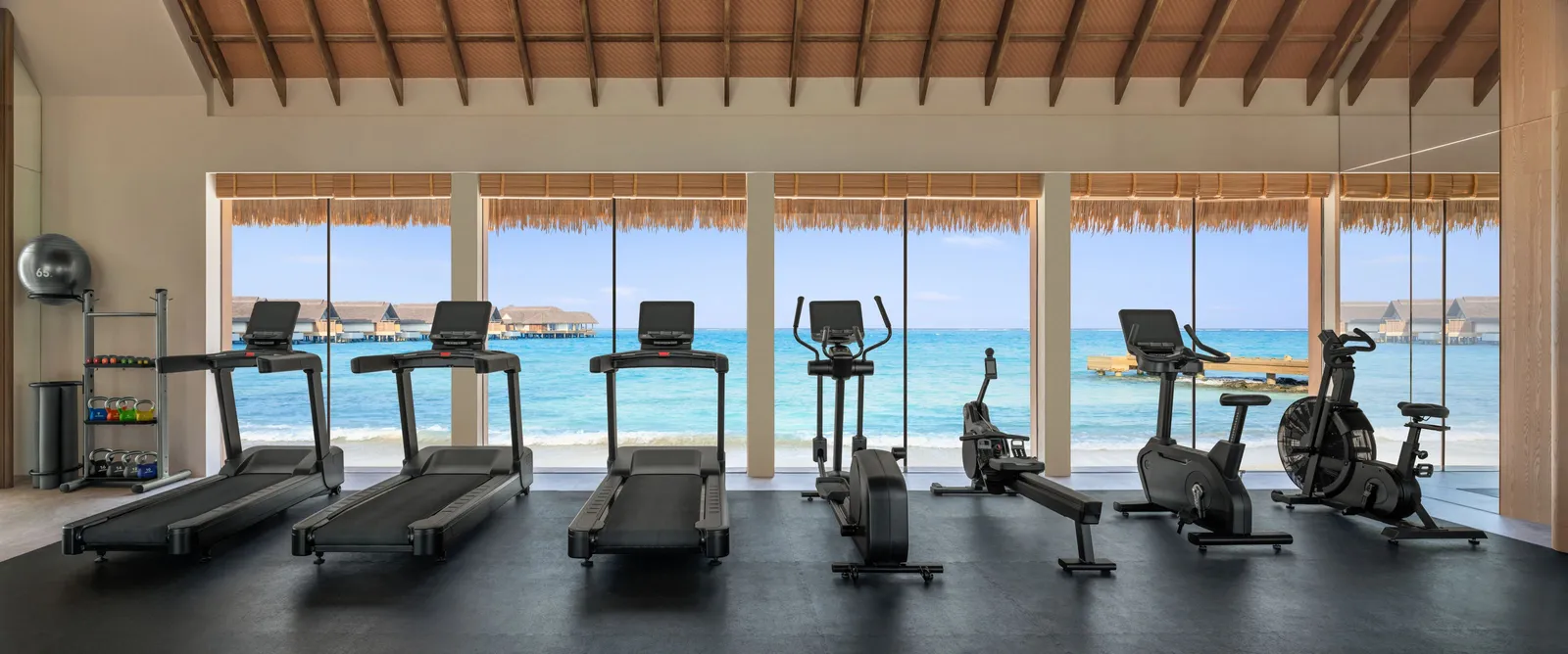 The gym, treadmills facing the windows on the lagoon