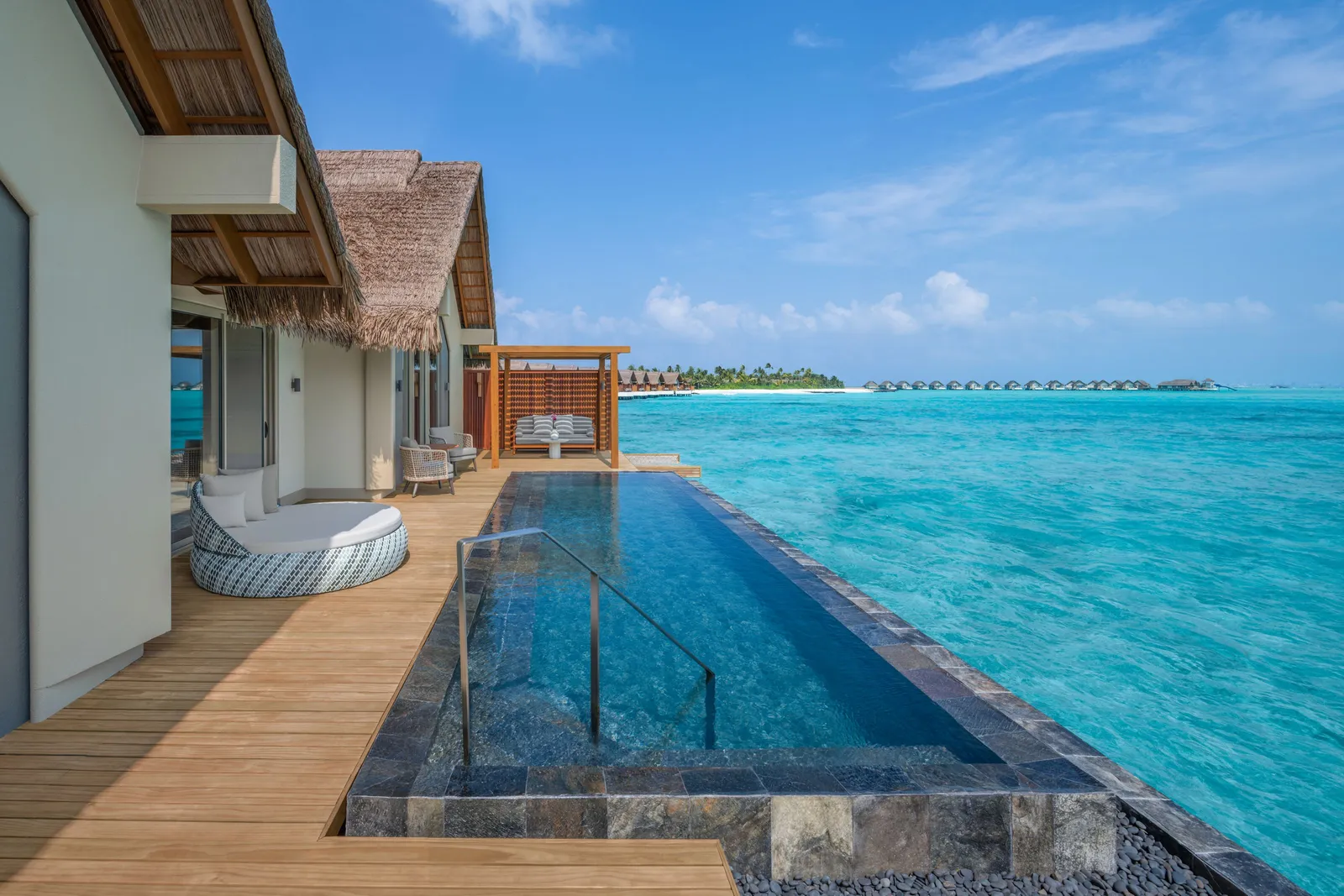 The long pool of the Two-Bedroom Overwater Pool Villa, out over the lagoon