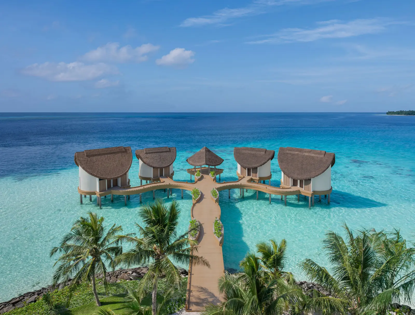The overwater spa rooms from above, joined by a walkway