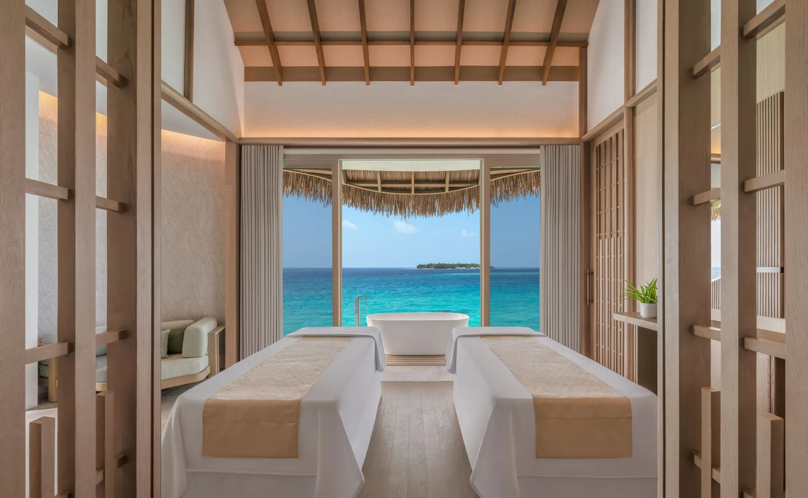 A spa room for 2, the beds facing the window on the sea