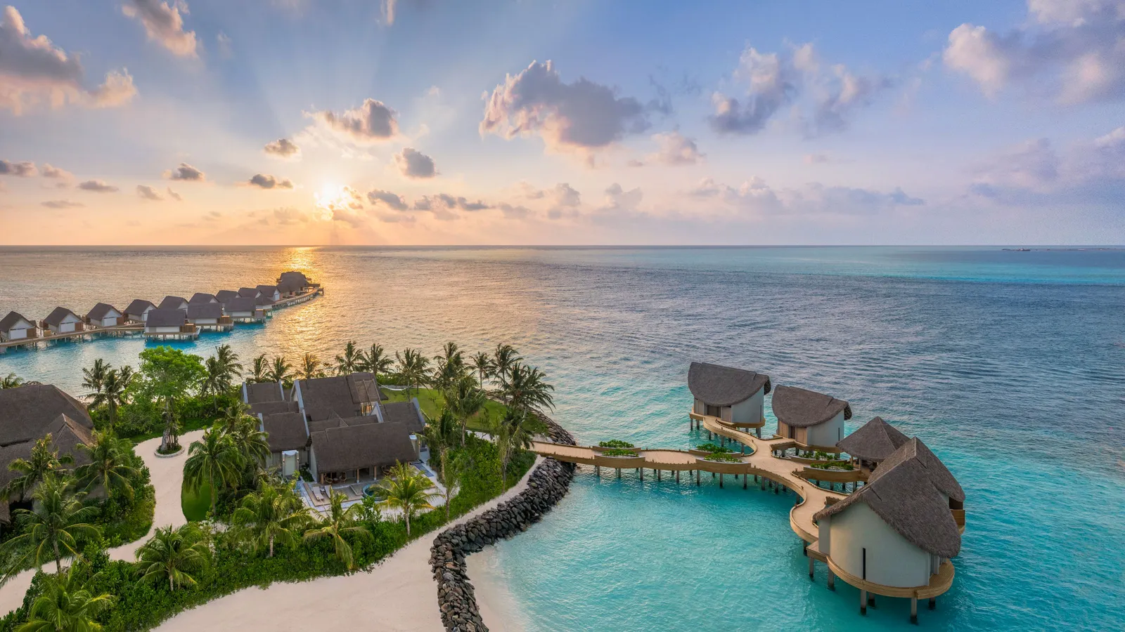 The overwater spa at sunrise, seen from above, the overwater villas behind