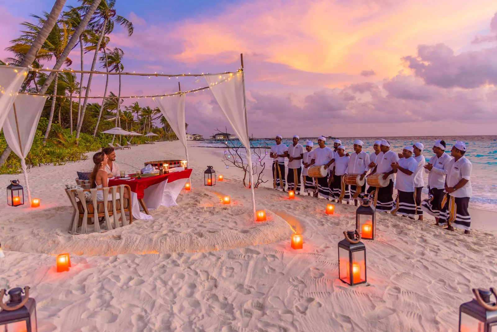 A Maldivian dinner on the beach at sunset, the bodu beru drummers lined up behind the table