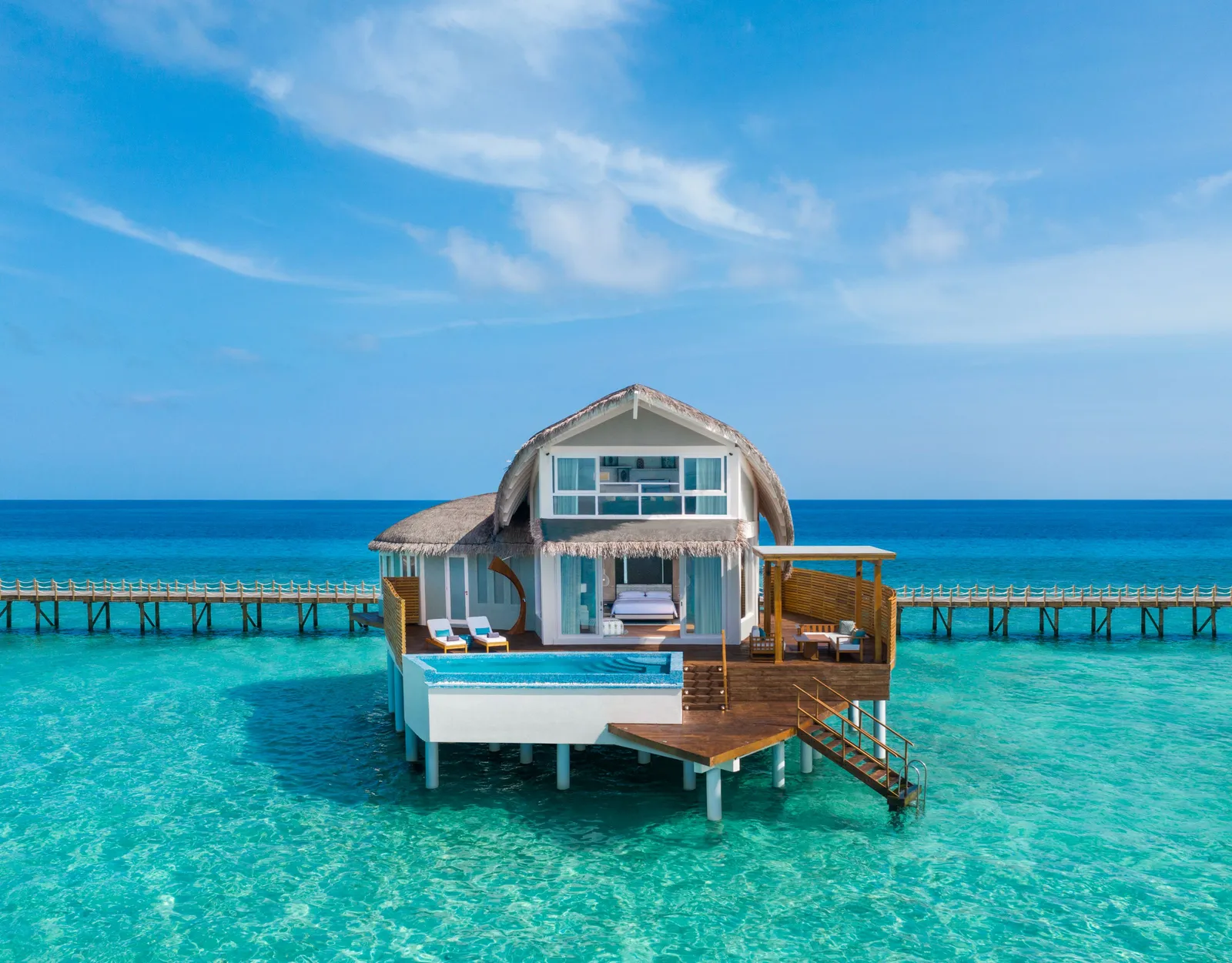 A Duplex Overwater Pool Villa on 2 floors, its deck pool and steps into the lagoon
