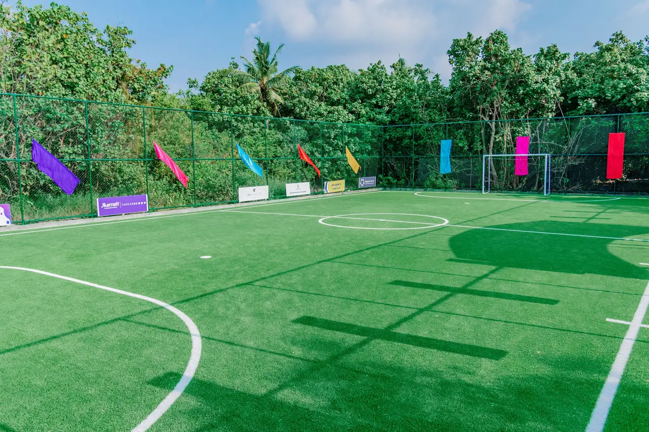 The artificial-grass football pitch among the island’s trees