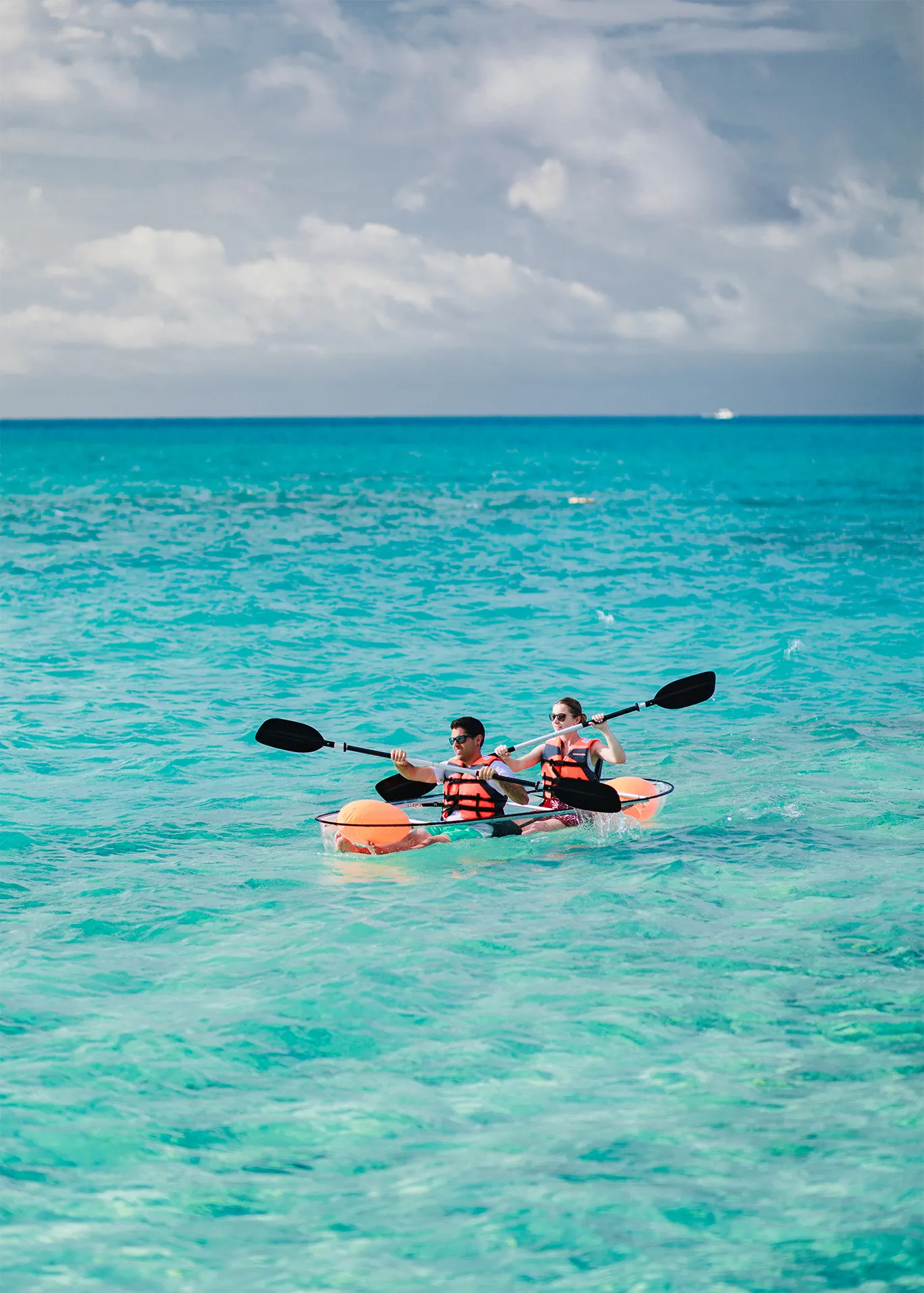 2 people kayaking on turquoise water