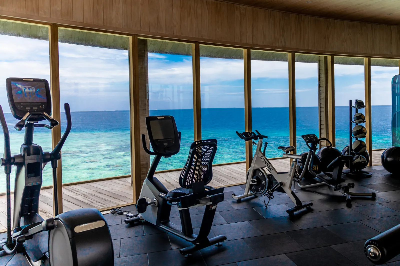 The overwater gym, machines before the windows on the lagoon