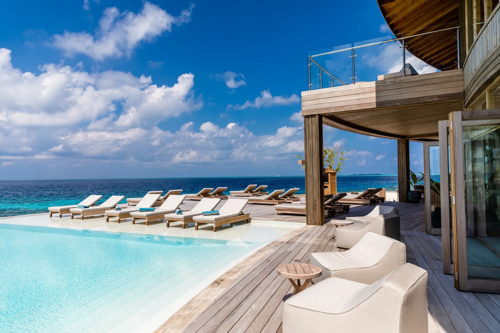 The main pool over the sea, loungers along its edge