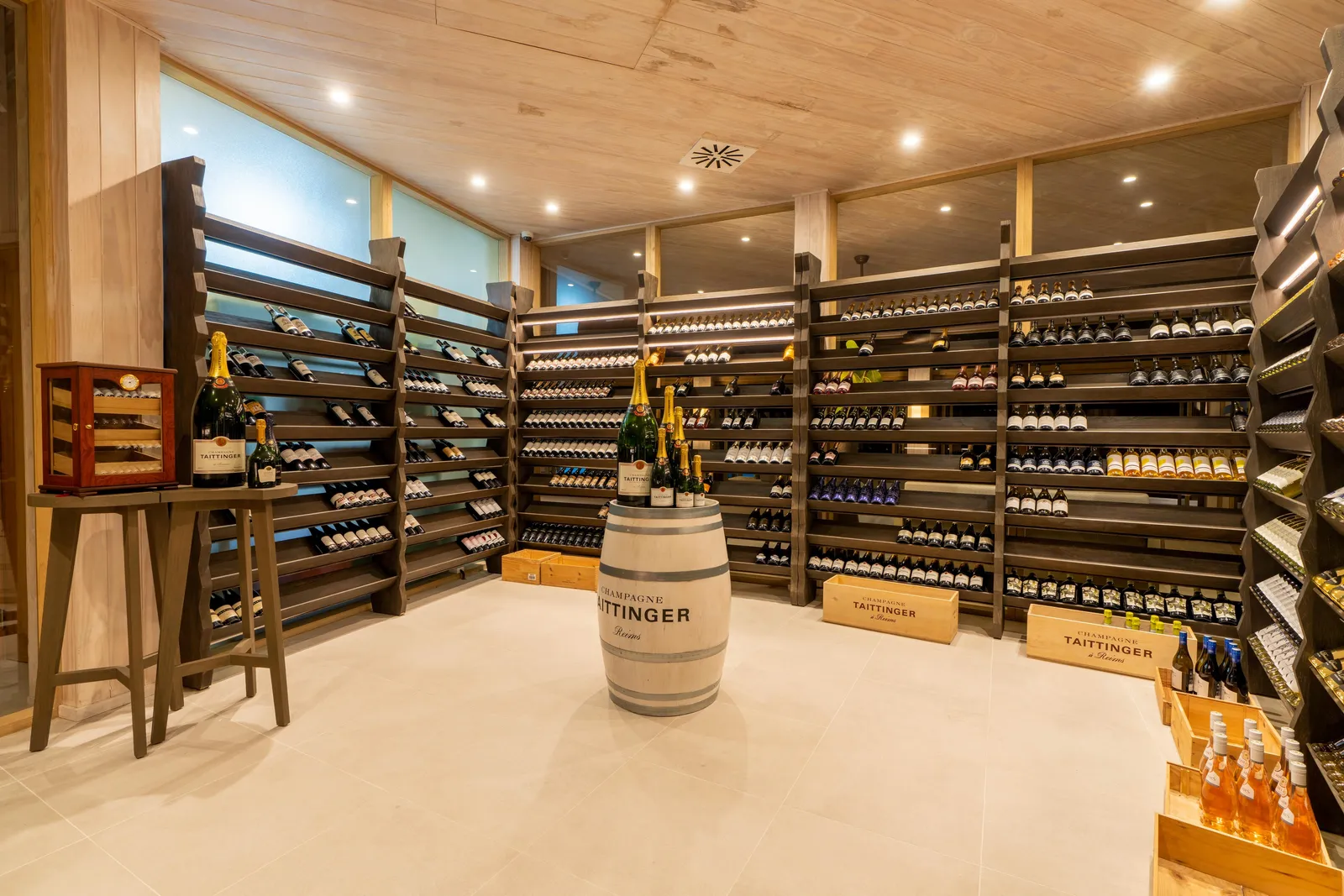 The wine cellar, bottles on the walls and a barrel in the middle