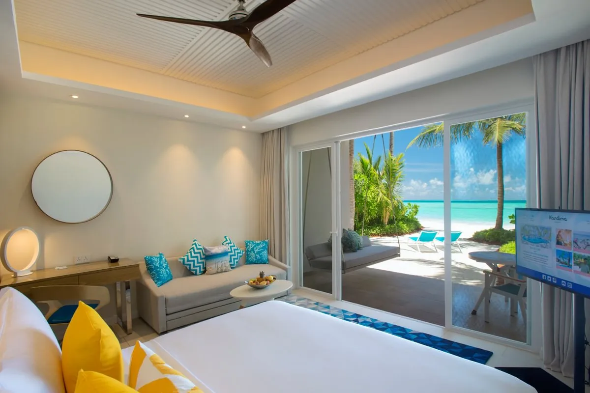 A Beach Studio, its bed, sofa and door open to the beach