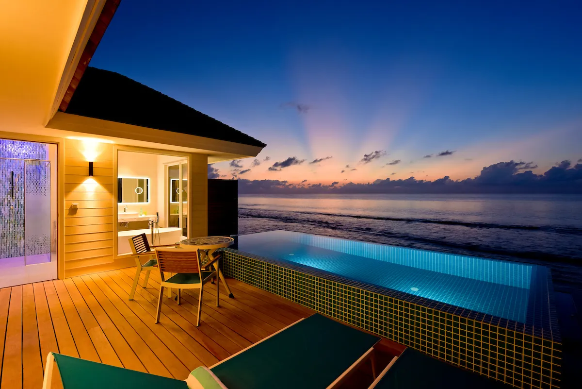 An Ocean Pool Villa’s deck pool at sunset