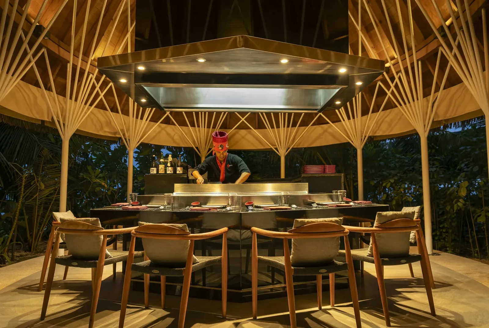 Banzai, the open-air teppanyaki under its bamboo vault, the chef at the grill