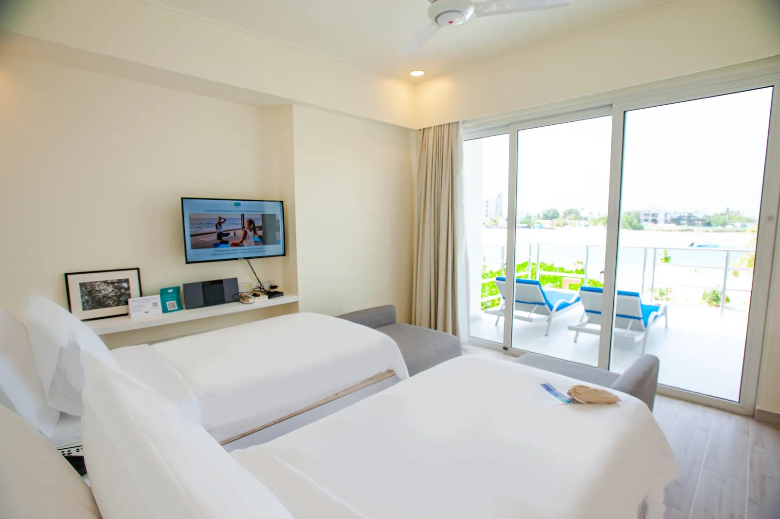 The twin bedroom of a 3-bedroom villa, with the door open onto the deck.