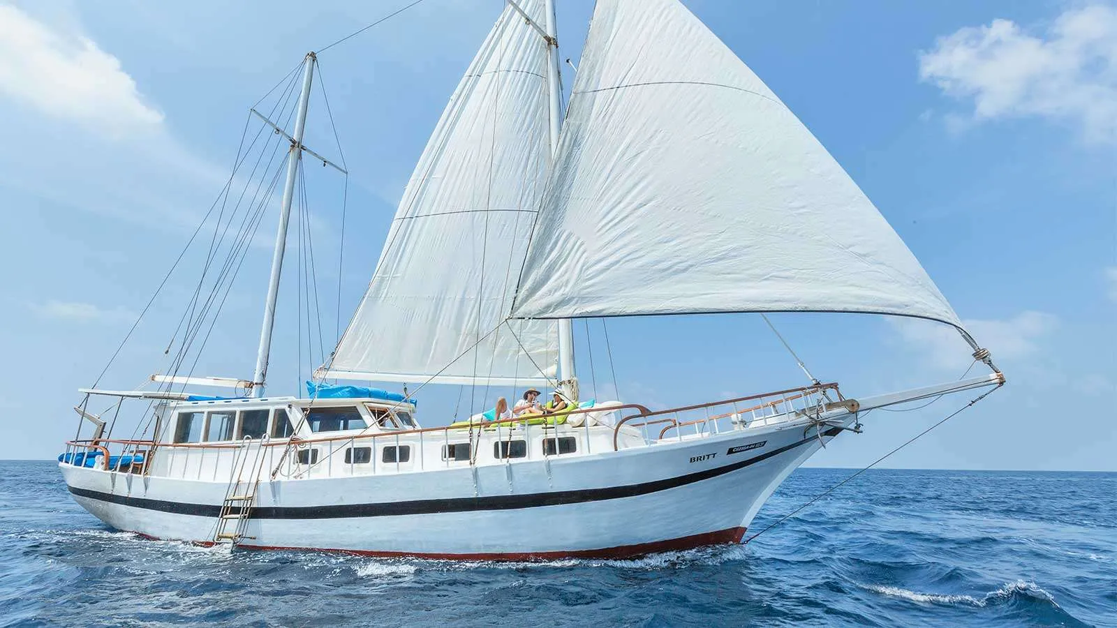 Britt, the resort’s motor sailing yacht, under full sail on the open sea.