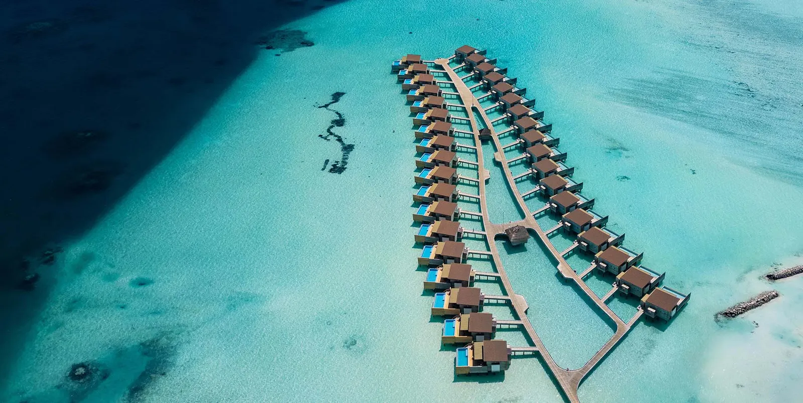The 2 rows of water villas from above, along the jetty that runs out into the turquoise lagoon.