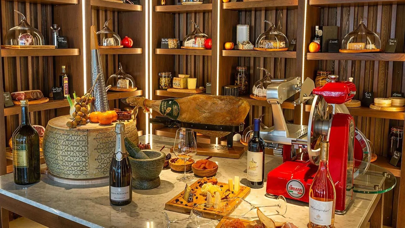 The Cheese Room: wheels of cheese, bottles and a board ready to serve