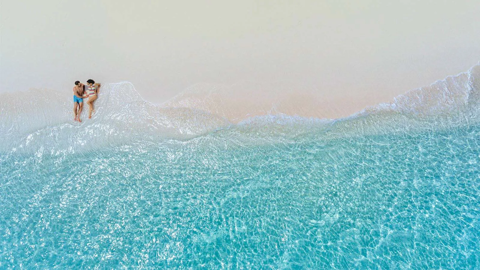 2 people in the shallows beside the Dream Island sandbank, seen from above