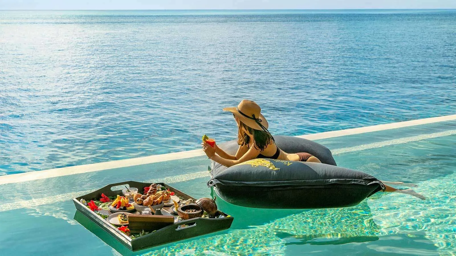 A breakfast tray floating in the residence pool