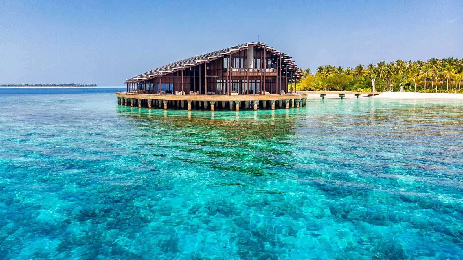 The Retreat, the 2-storey building over the water, the island and its palms behind