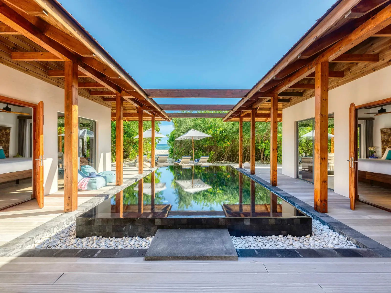 A beach residence’s courtyard, the long pool between the rooms