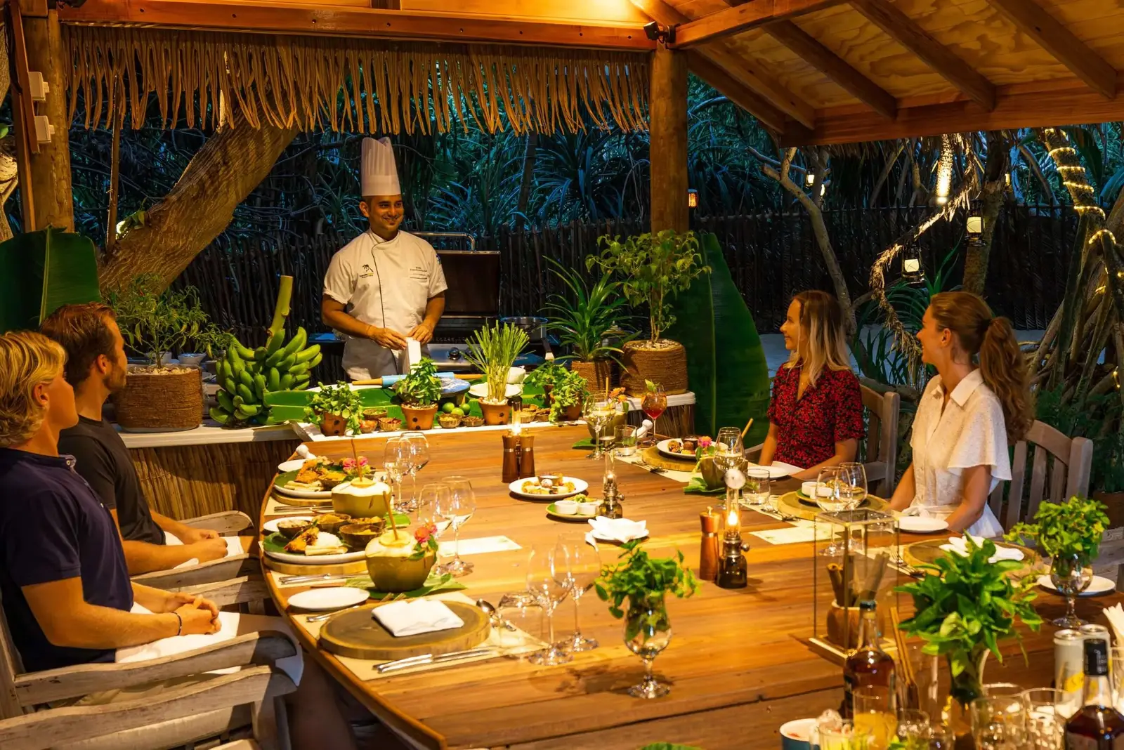 The chef prepares dinner in front of 4 guests