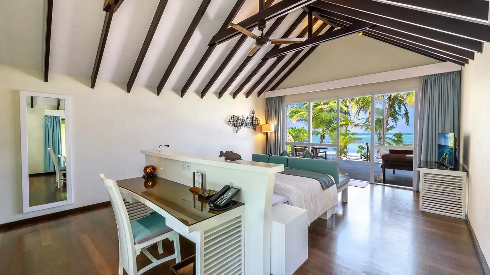 Deluxe Beach Villa bedroom opening onto the veranda