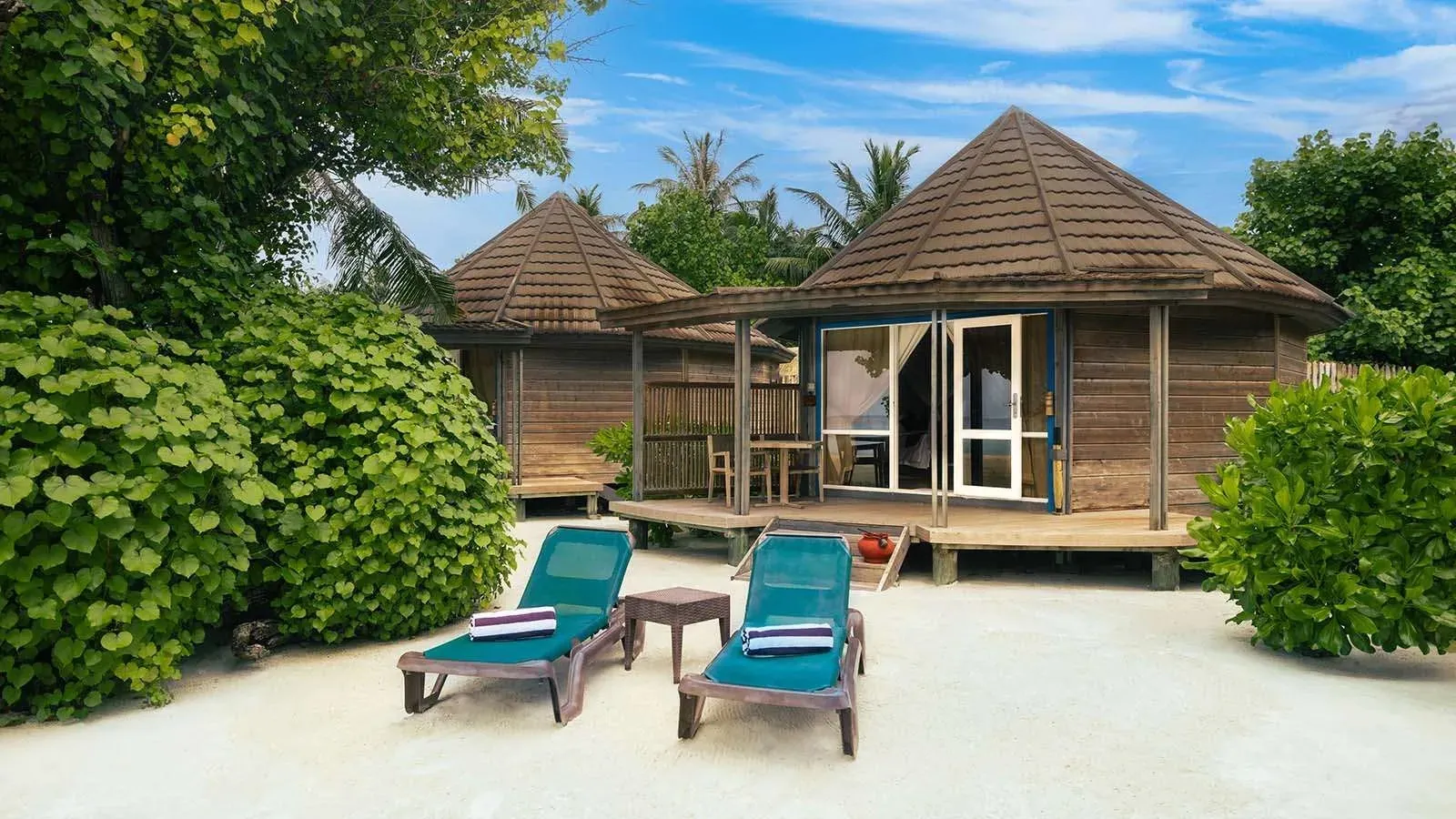 O Jacuzzi Beach Villa seen from the beach, with loungers in front