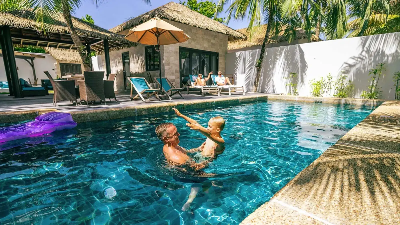 A family in the Private Pool Villa Family Suite pool
