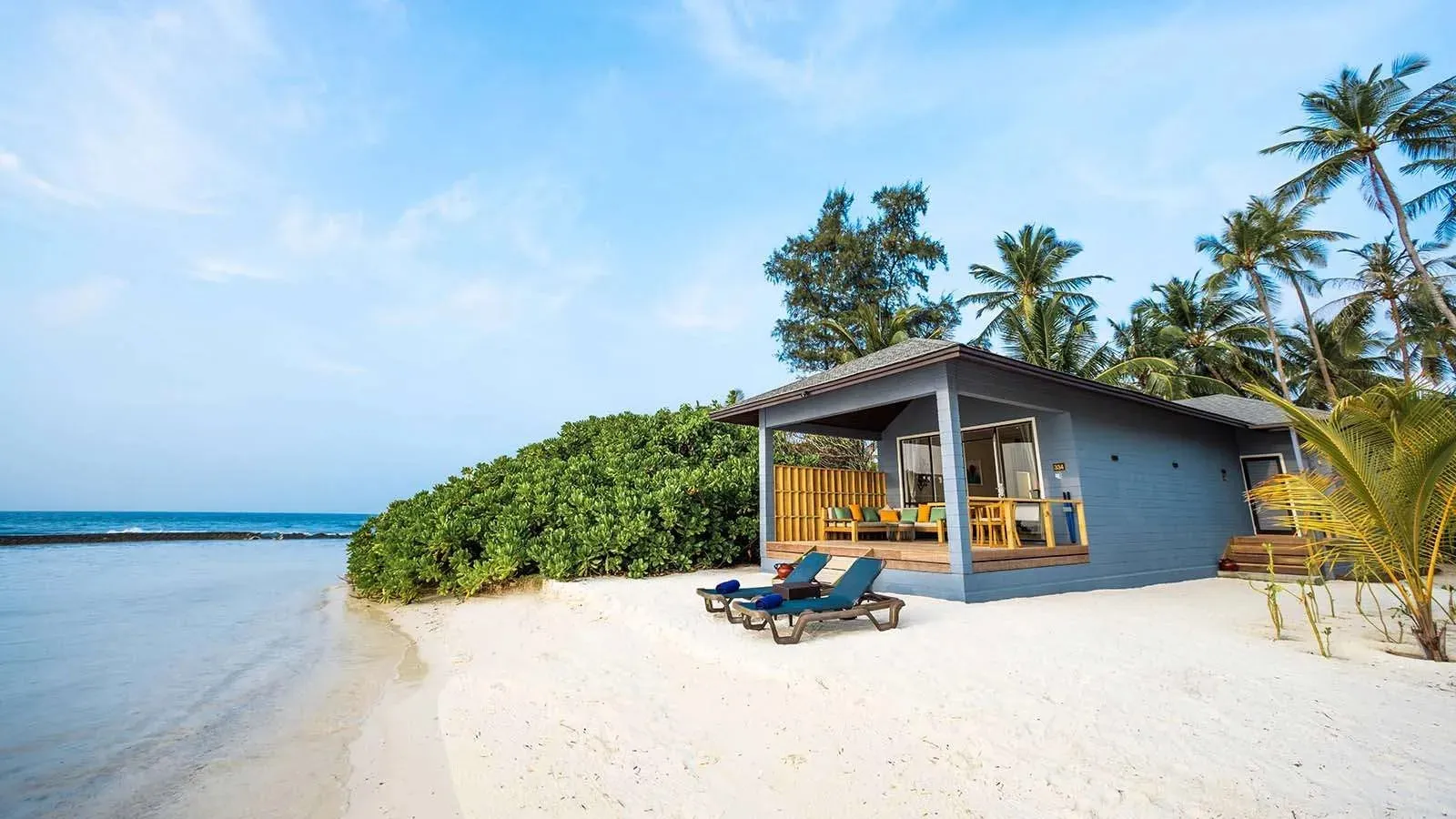 2 Bedroom Beach Villa in front of the beach, with loungers and a parasol