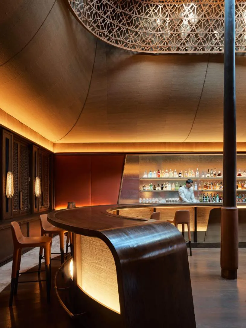 A dim bar with a lit counter