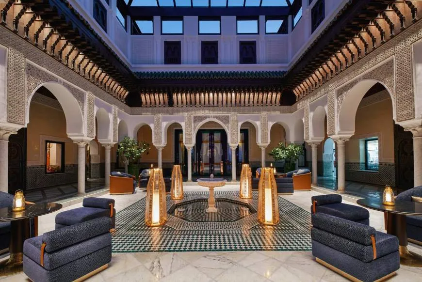 An arcaded courtyard restaurant with lanterns and sofas