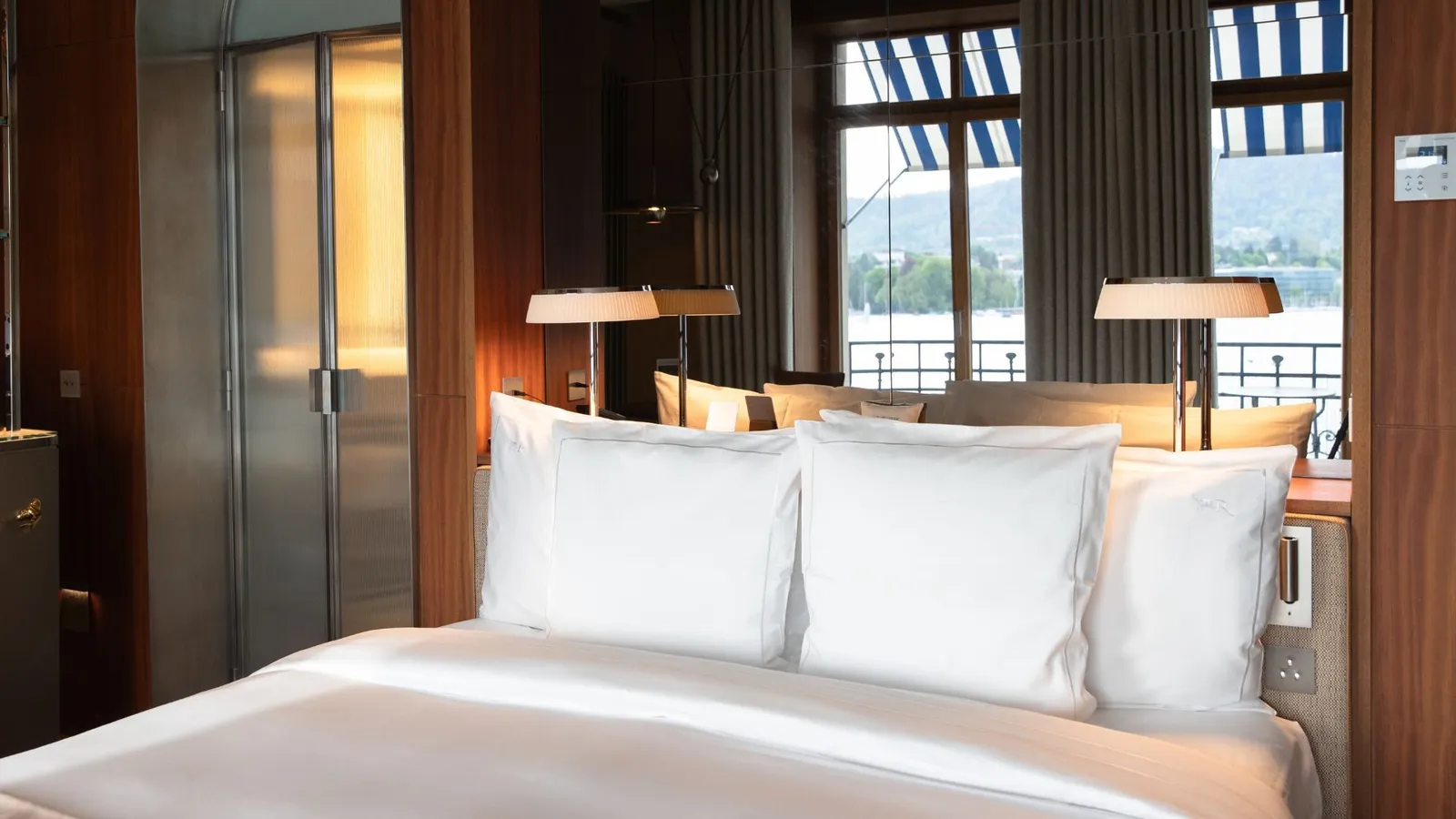 Bed by the lake-facing windows