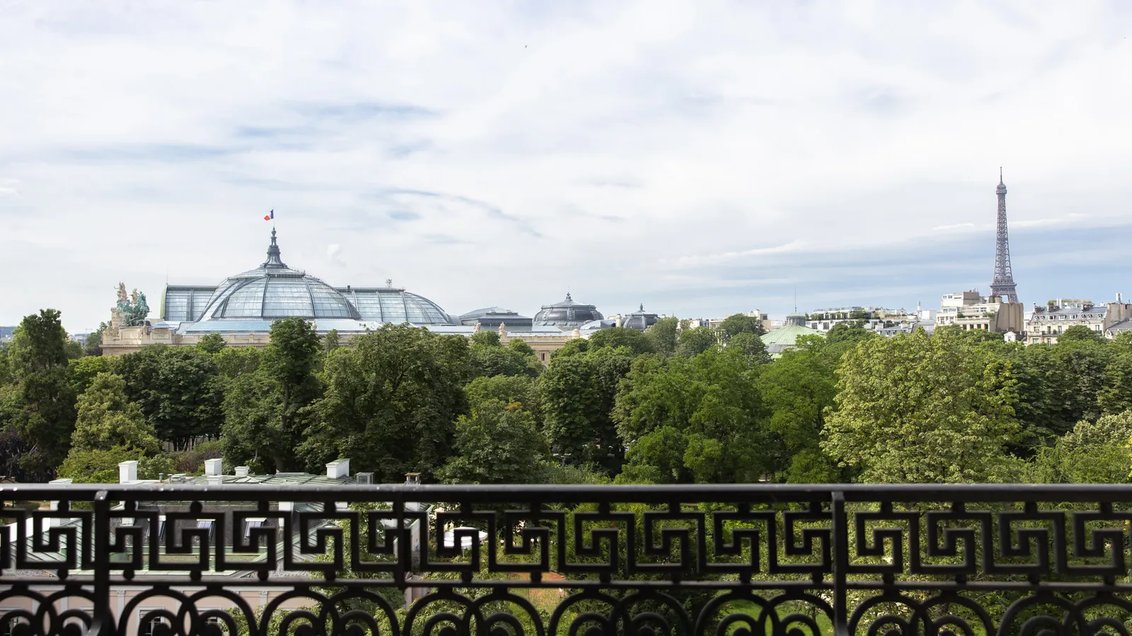 A view from the balcony towards the Eiffel Tower beyond the trees