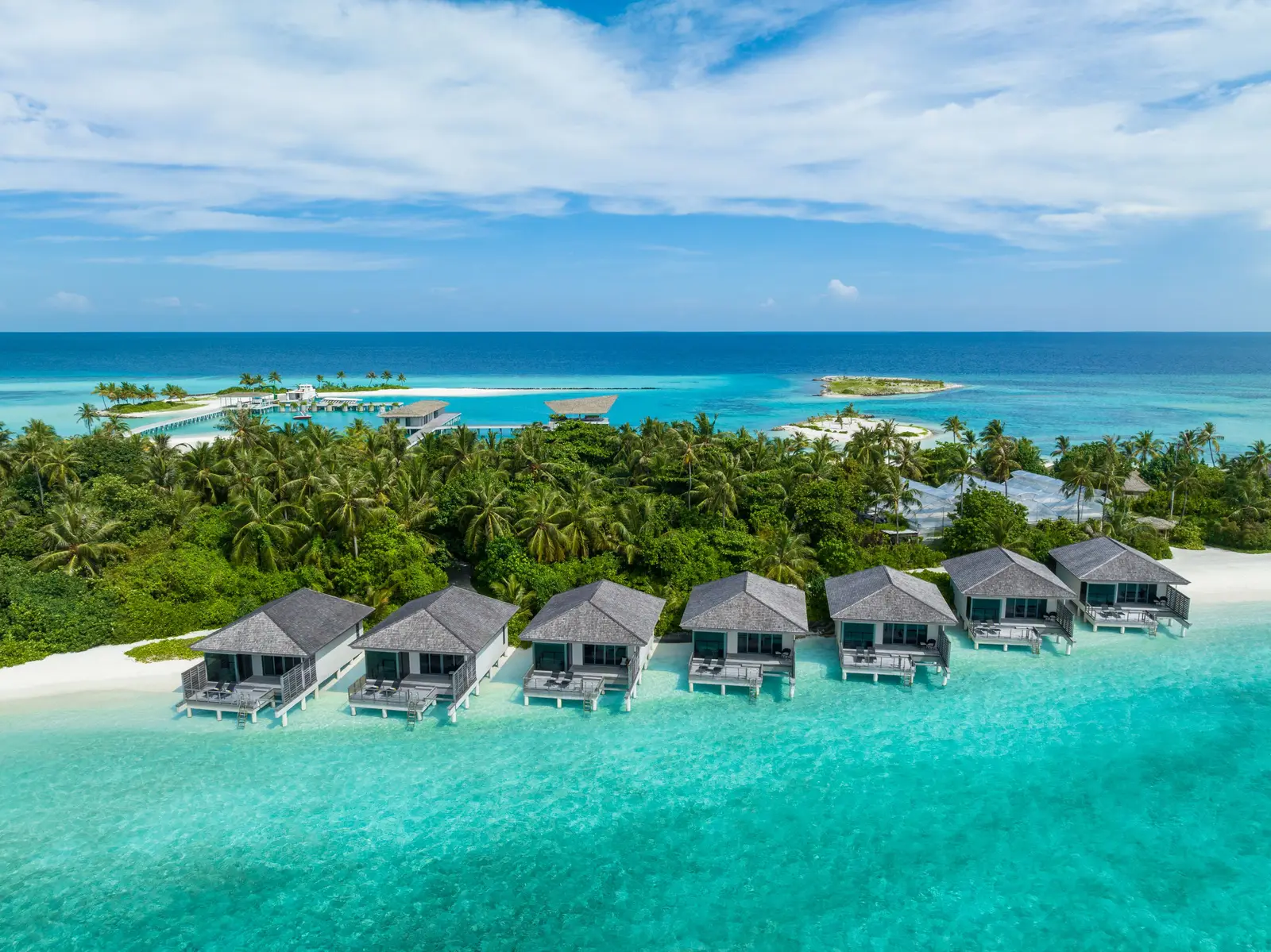 The Lagoon Villas in a row on the beach, from above, the lagoon in front