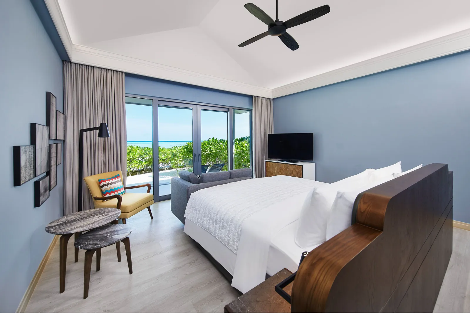 A Beach Villa’s bedroom, the bed and the windows onto the garden