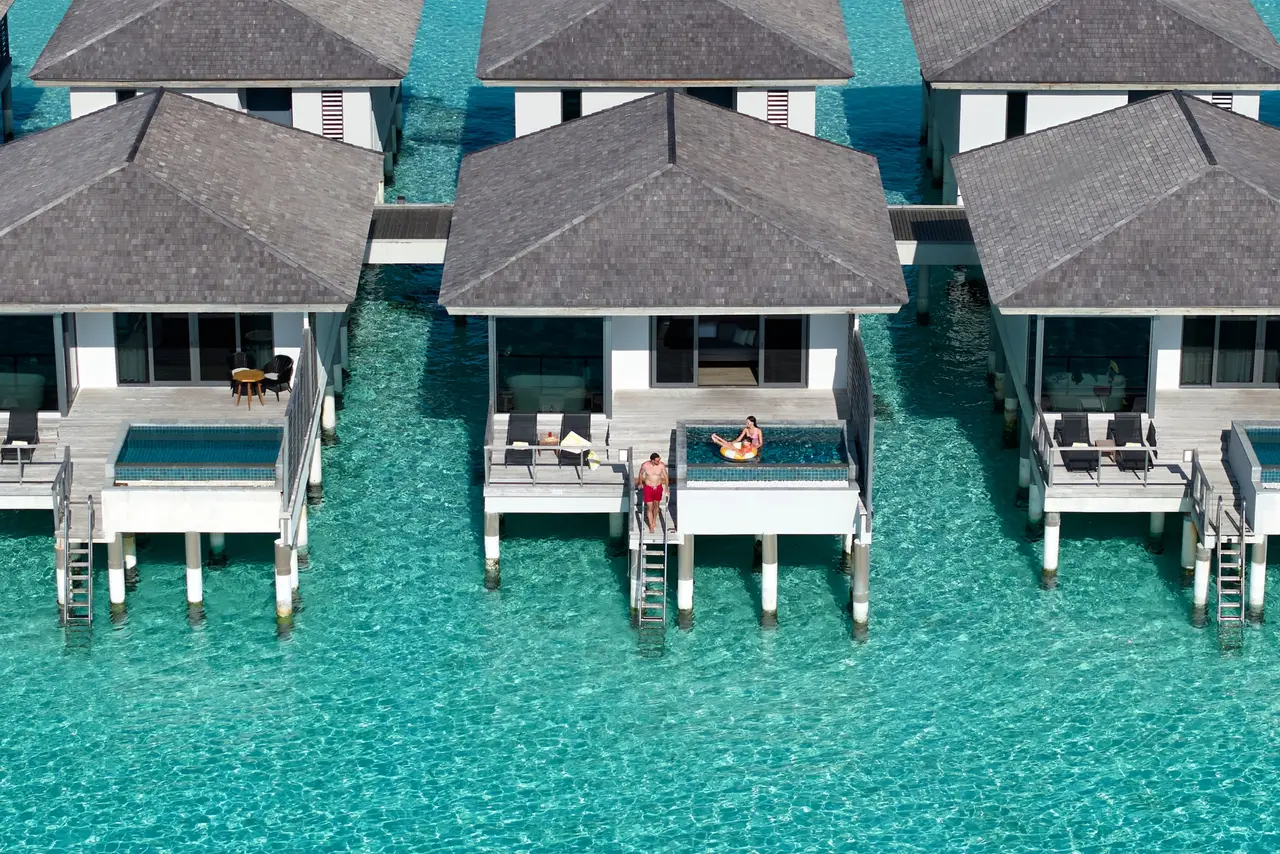 The overwater pool villas from above, each with its pool on the deck