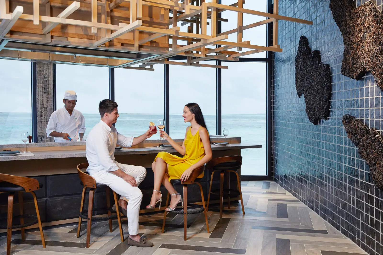 A couple at Tabemasu’s teppanyaki counter, the chef cooking in front of them