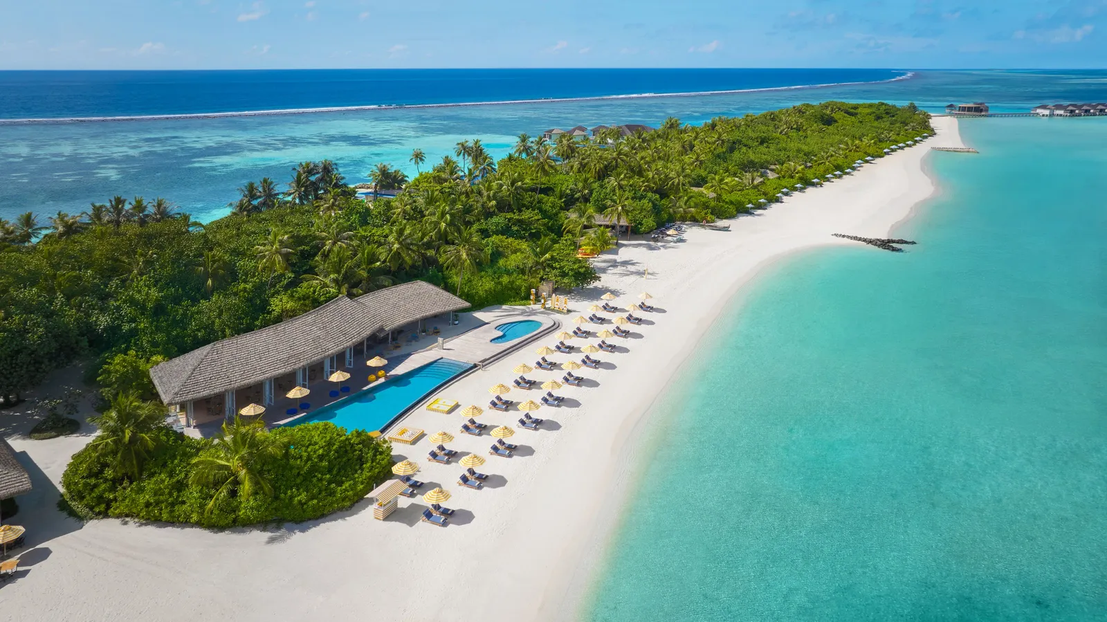 Velaa Bar + Grill and its pool from above, on the long white beach
