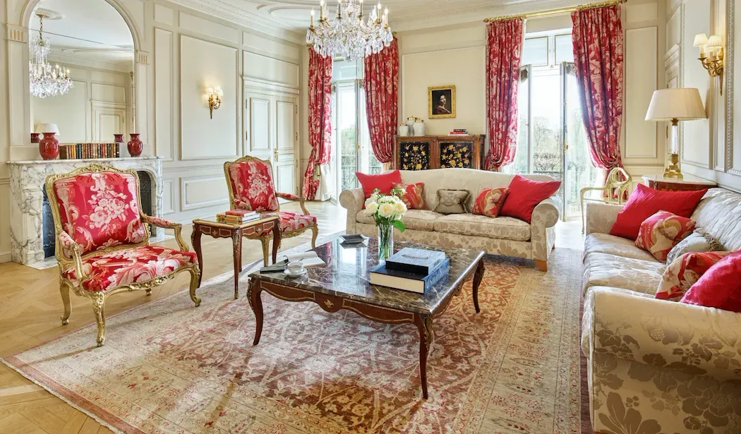 Presidential Apartment Dalí, Park View at Le Meurice, with red floral armchairs, cream sofas and red curtains