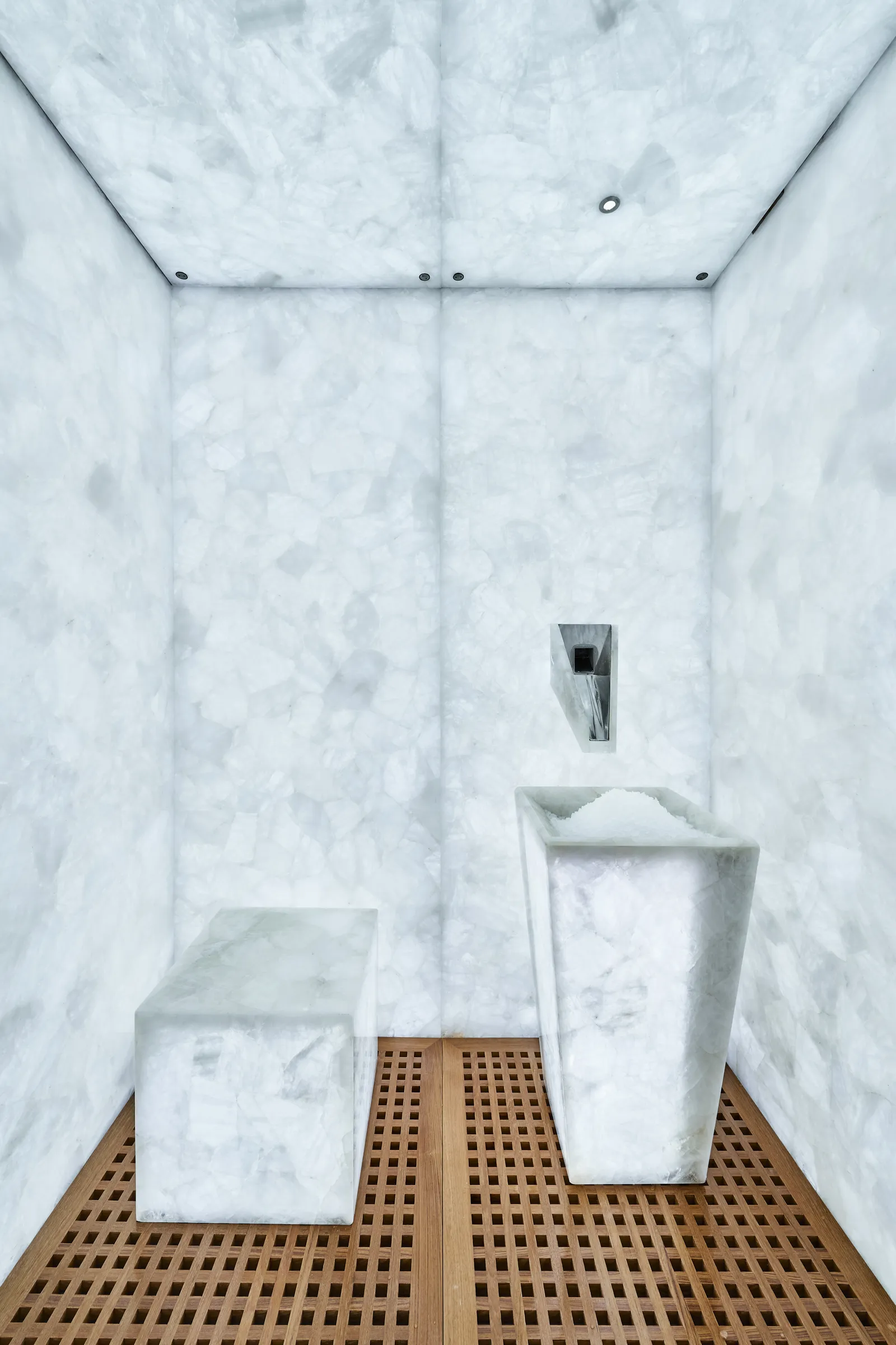 The spa’s ice room: lit onyx walls and blocks of white stone.