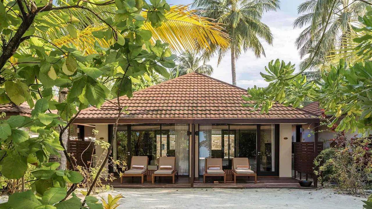 A red-roofed Beach Family Villa among the palms